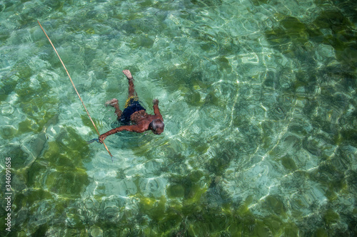 Borneo, Malaysia - 30th November, 2018 : A fisherman of the sea gypsies tribe is fishing with a traditional spear.