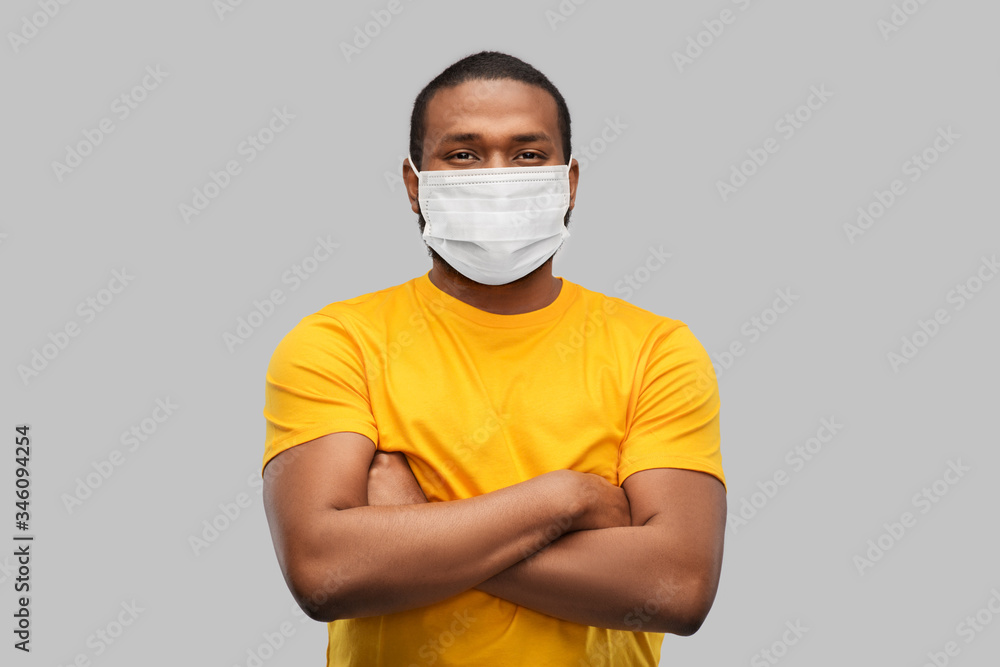 health, pandemic and safety concept - african american young man wearing face protective medical mask for protection from virus disease over grey background health, pandemic and safety concept - african american young man wearing face protective medical mask for protection from virus disease over grey background