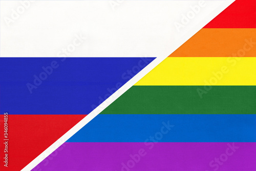 Russia or Russian Federation national fabric flag vs rainbow flag of LGBT community from textile opposite each other.