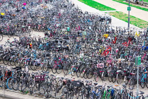 The Netherlands August 20, 2020.  Bicycle parking with bicycles parked near the train station, sunny day, Netherlands