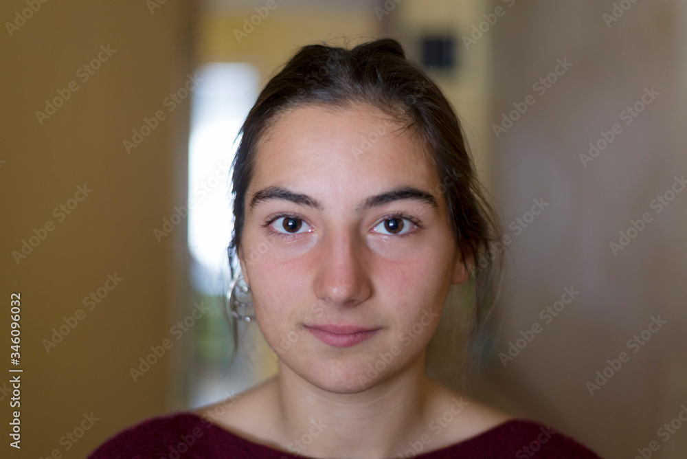 Closeup portrait of a young woman looking camera Closeup portrait of a young woman looking camera