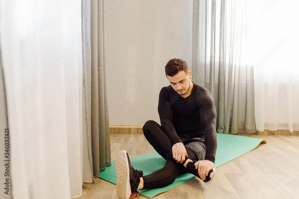 young man making sport exercises at home