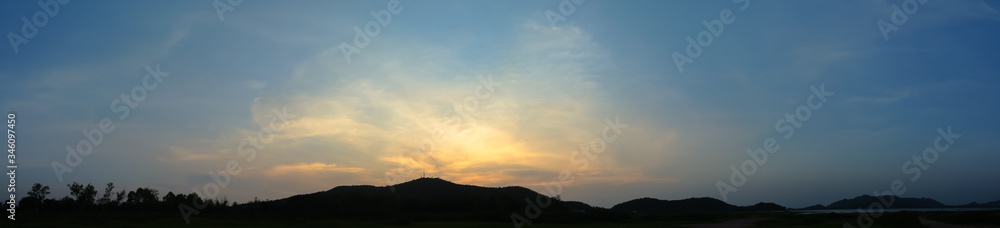 Fototapeta premium Panoramic view of sunset sky and clouds at hill and lake