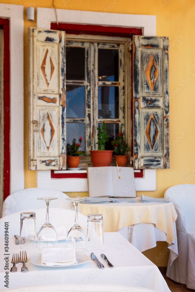 Fototapeta premium Open restaurant terrace with amazing sea view on Santorini island. Cyclades, Greece