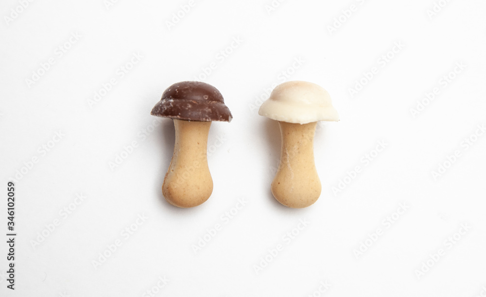 cookies and chocolate in the shape of mushrooms on a white background cookies and chocolate in the shape of mushrooms on a white background