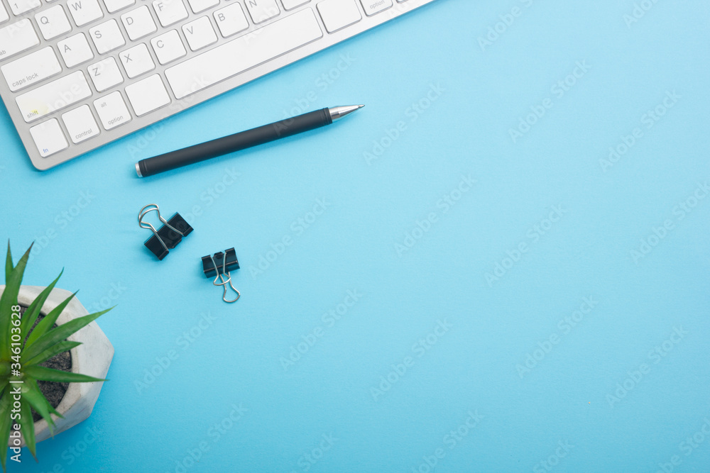 Blue desk office with laptop, smartphone and other work supplies with cup of coffee. Top view with copy space for input the text. Designer workspace on desk table essential elements on flat lay Blue desk office with laptop, smartphone and other work supplies with cup of coffee. Top view with copy space for input the text. Designer workspace on desk table essential elements on flat lay