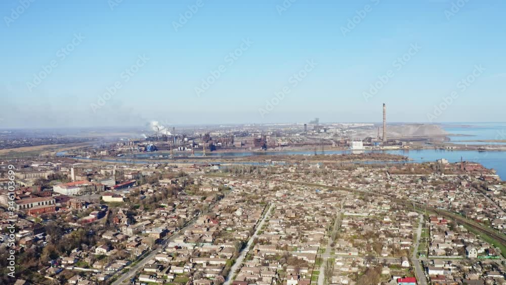Aerial view of high chimney pipes with grey smoke. Factory in the city. Industrial factory pollution. Emission to atmosphere from industrial pipes. Aerial view of high chimney pipes with grey smoke. Factory in the city. Industrial factory pollution. Emission to atmosphere from industrial pipes.