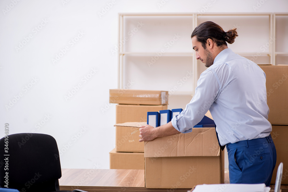 Young male employee in relocation concept Young male employee in relocation concept