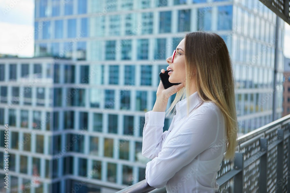 Real estate agent talking on the phone. in the background modern buildings, office buildings Real estate agent talking on the phone. in the background modern buildings, office buildings