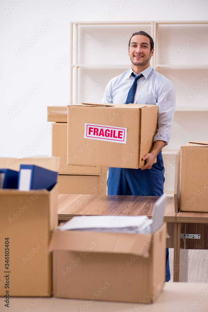 Young male employee in relocation concept Young male employee in relocation concept