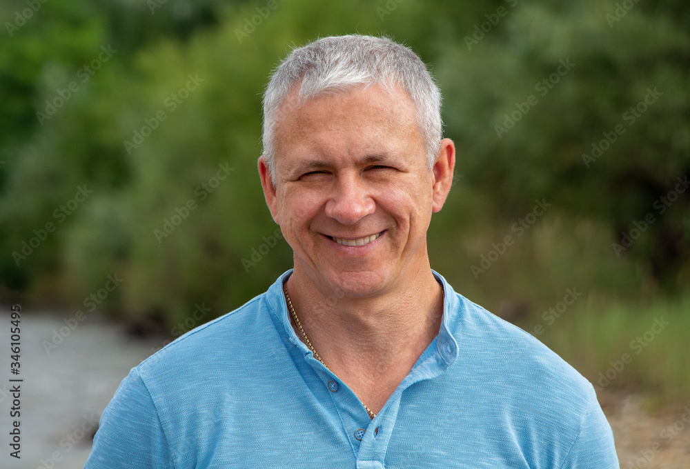 Portrait of a happy man on a background of nature. Portrait of a happy man on a background of nature.