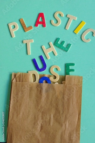 Don't use the plastic  written in wooden letters coming out of a paper bag on a colored cardboard