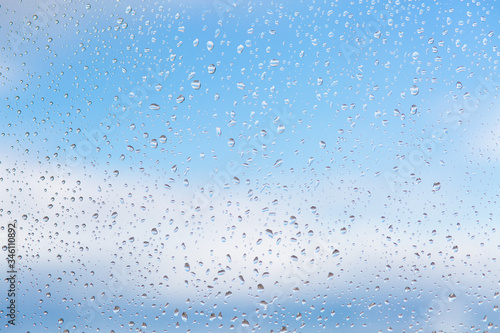 raindrops on glass sky texture. Pure blue fresh clean. Window view background screensaver. Place for text banner. Drops after rain wet sunny day wallpaper silence calm summer freshen up