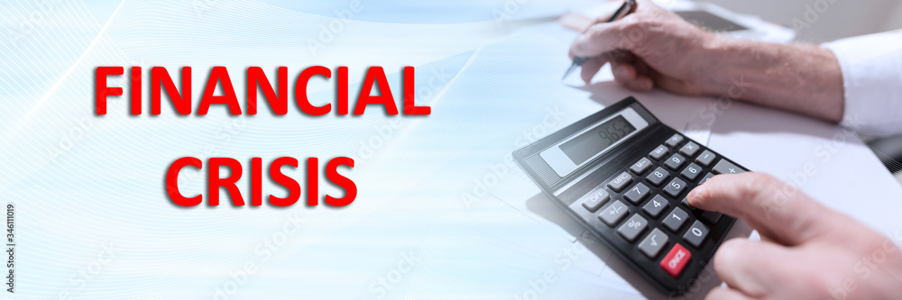 Concept of financial crisis with businessman using calculator at office Concept of financial crisis with businessman using calculator at office