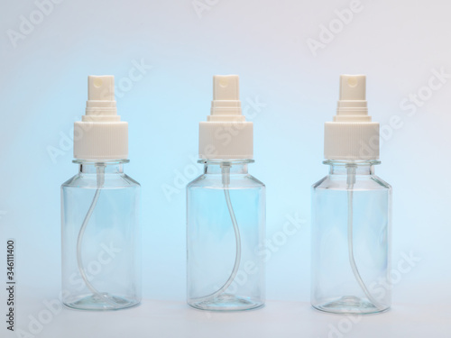 three clear bottles with a spray for antiseptic against coronovirus covid19