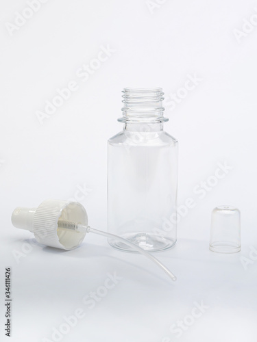 transparent bottle with a spray for antiseptic against coronovirus covid19 to protect hands and surfaces from infection with the virus