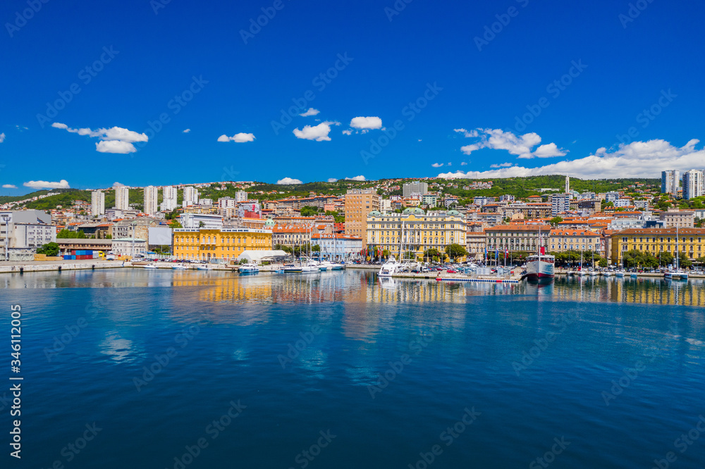 Croatia, city of Rijeka, aerial panoramic view of city center, marina and harbor from drone, reflection in sea

