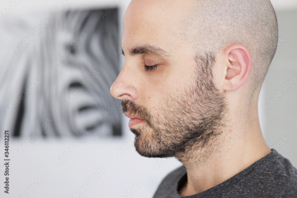 Fototapeta premium Caucasian man is meditating at home