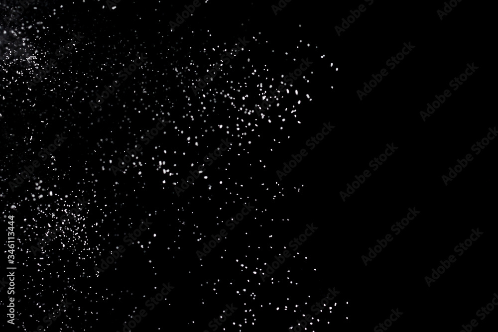 White powder explosion isolated on black background.White dust particles splash. White powder explosion isolated on black background.White dust particles splash.