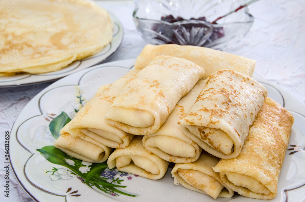 tasty pancakes in a plate on a light background. Pancakes with jam. tasty pancakes in a plate on a light background. Pancakes with jam.