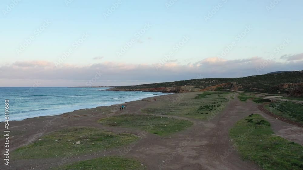 Aerial drone video of group of runners running on the beach at the morning. Pegeia Paphos Cyprus Aerial drone video of group of runners running on the beach at the morning. Pegeia Paphos Cyprus