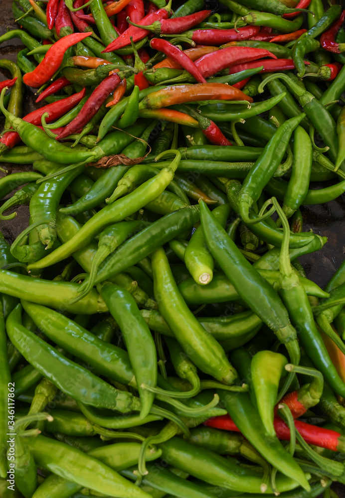 Green and red chili on a counter top of a store during food festival market. Green and red chili on a counter top of a store during food festival market.
