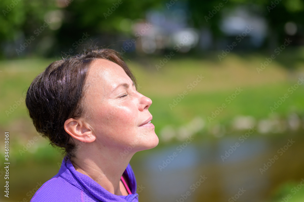 Blissful woman enjoying the spring sunshine Blissful woman enjoying the spring sunshine