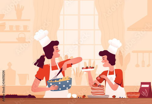 Cheerful kids in cook hats prepare pancakes at home in the kitchen. The concept of children's cooking and interesting homework