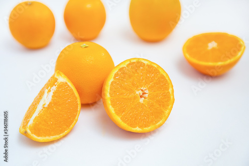 Group of juicy oranges isolated on white background. Studio shot. Selective focus. Close-up side view. Citrus fruit and healthy food concept