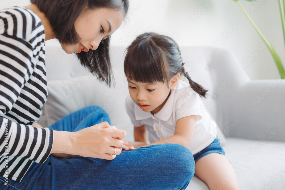 Little daughter with mother making pedicure at home Little daughter with mother making pedicure at home