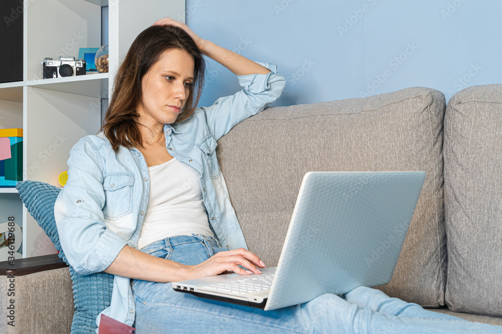 Woman or successful working at home interior on smart phone and laptop computer on remote internet distance work Woman or successful working at home interior on smart phone and laptop computer on remote internet distance work