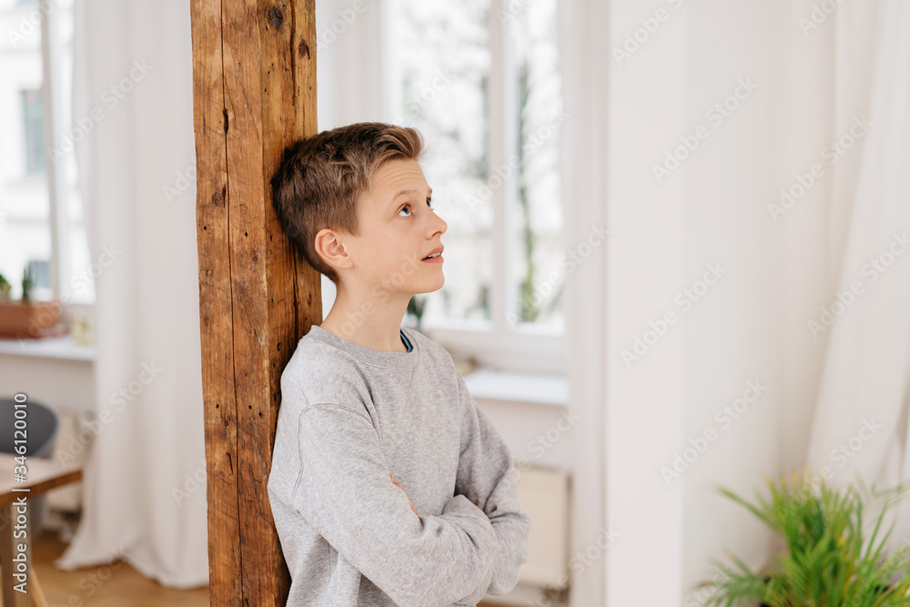 Young boy looking up deep in thought Young boy looking up deep in thought