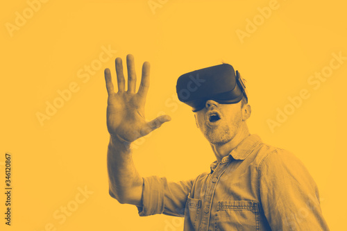Man in his 30's wearing a VR virtual reality headset. Graphic duotone style