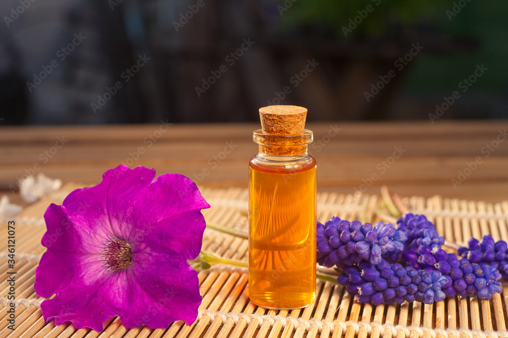 Essential oil of muscari flower on a table in beautiful bottle Essential oil of muscari flower on a table in beautiful bottle
