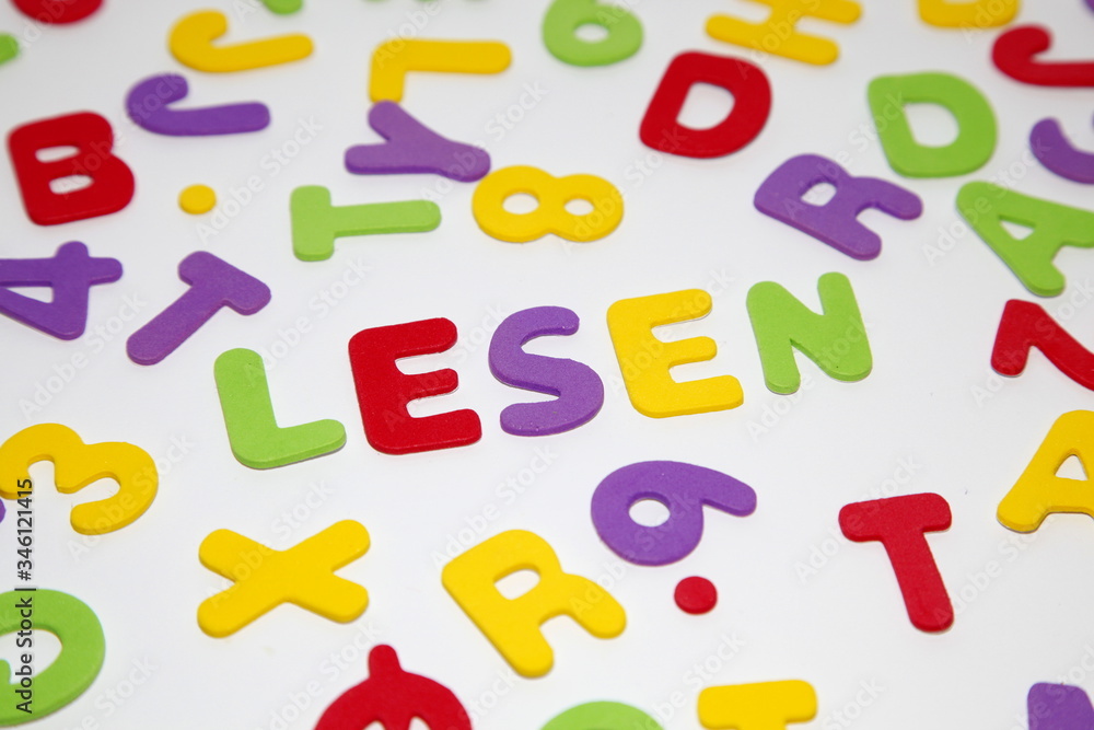 close-up of the german word LESEN - reading - and seamless pattern with letters of the alphabet and numbers in random order on a white background. Education and Back to school concept close-up of the german word LESEN - reading - and seamless pattern with letters of the alphabet and numbers in random order on a white background. Education and Back to school concept