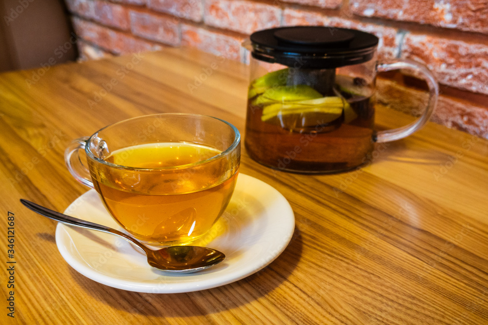 Cup and teapot filled with herbal tea Cup and teapot filled with herbal tea