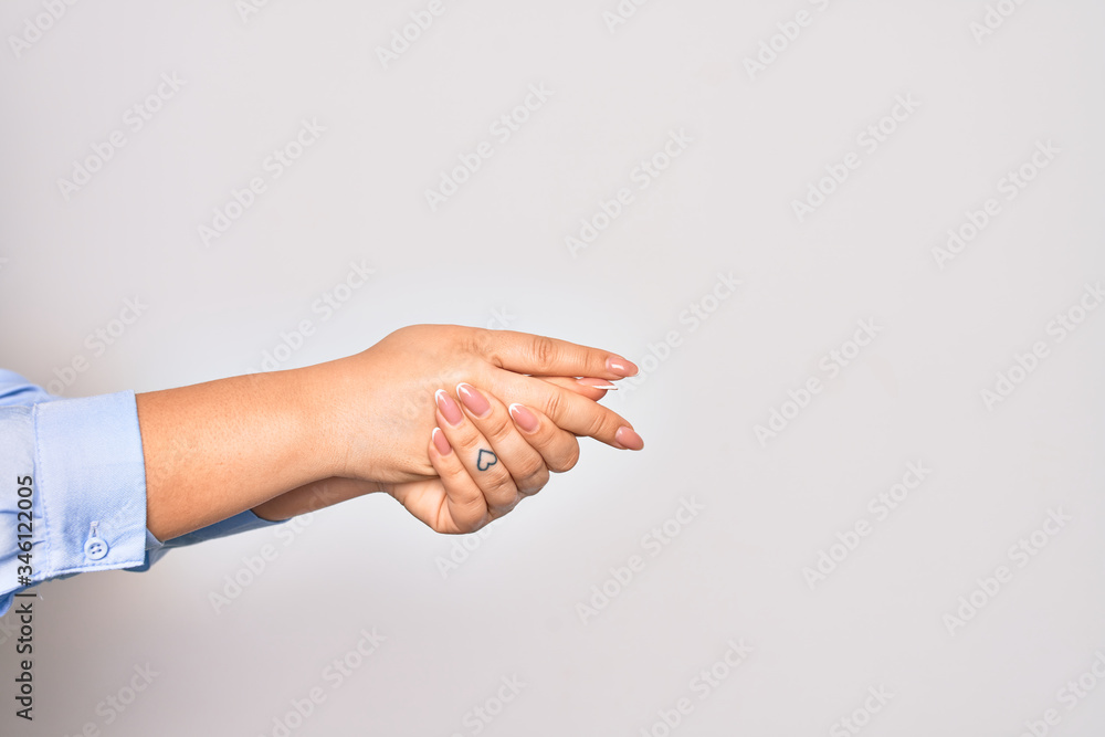 Young caucasian woman cleaning hands using alcohol liquid over isolated white background Young caucasian woman cleaning hands using alcohol liquid over isolated white background