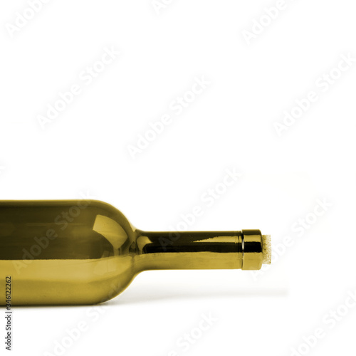 A bottle tinted in golden color, lies on its side, isolated on a white background with shadow, cropped image