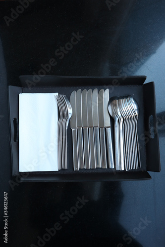 Place Setting with Knife, spoon and Fork  with tissue paper is in the black tray.