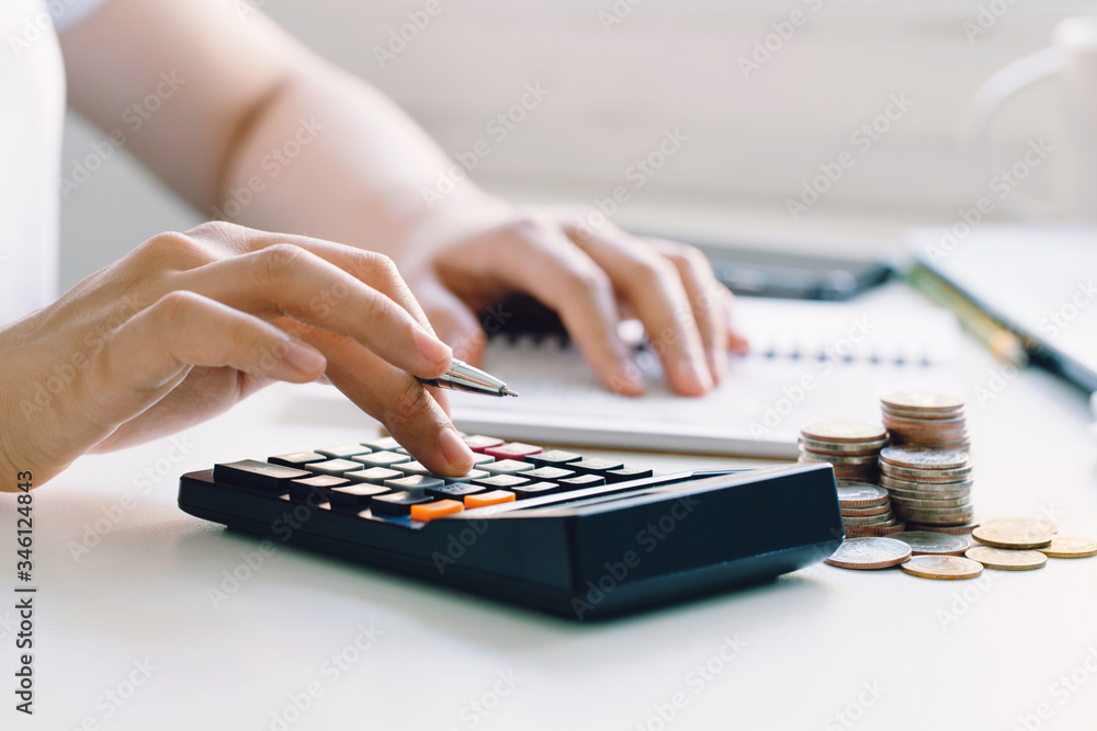 Young woman calculating monthly home expenses, taxes, bank account balance and credit card bills payment.income tax for pay taxes Young woman calculating monthly home expenses, taxes, bank account balance and credit card bills payment.income tax for pay taxes
