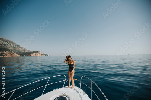 Young woman in swimwear sta...