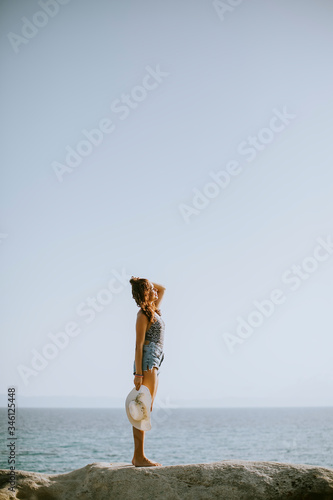 Young woman in bikini stand...