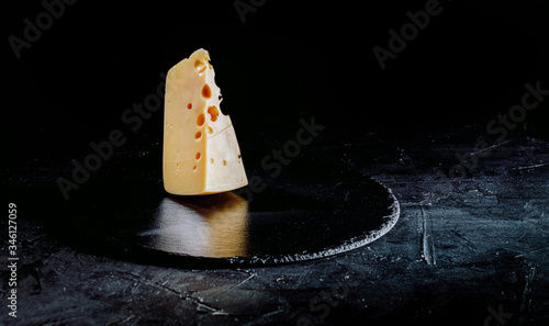 Delicious dutch cheese on dark background. Copy space