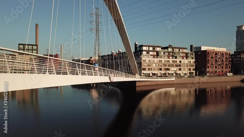 4K Helsinki Baltic Sea Finnish Bay lagoon early summer morning aerial video, Kalasatama upmarket neighborhood near Mustikkamaa Island over calm water channel in Finland capital Suomi northern Europe photo