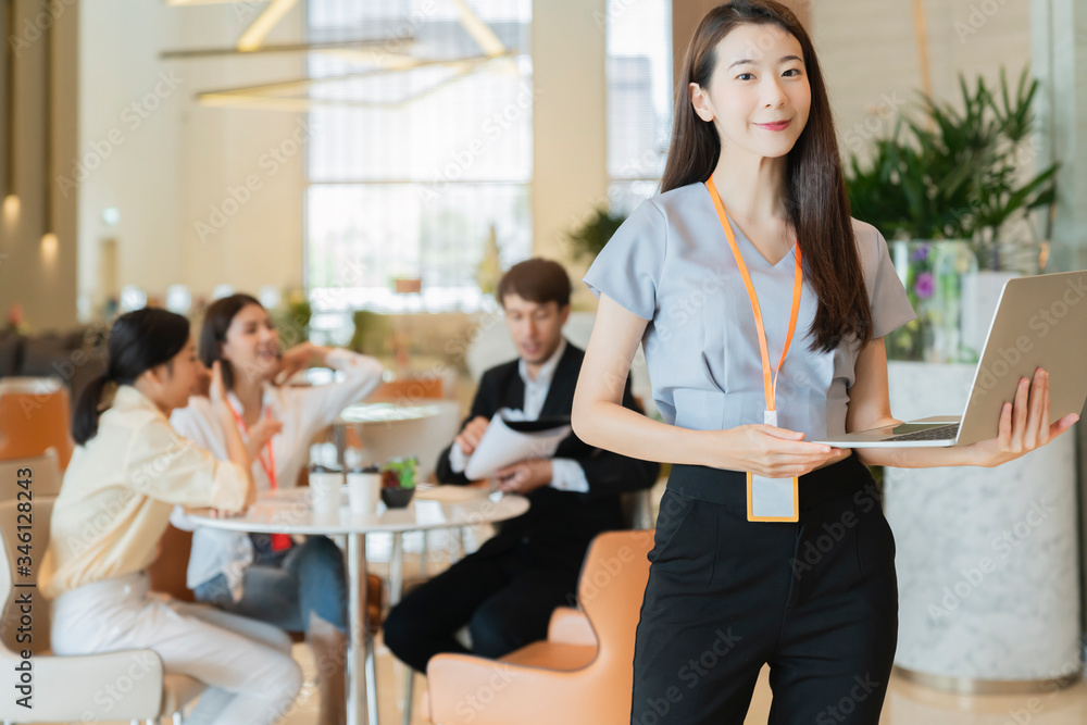 portrait Asian business people standing with confident and cheerful with business teamwork meeting brainstorm with laptop and paper document modern office background portrait Asian business people standing with confident and cheerful with business teamwork meeting brainstorm with laptop and paper document modern office background
