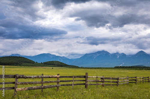 wooden fence in the valley with mountains, Arshan, Tunka valley