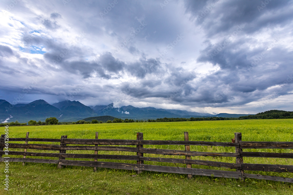 wooden fence in the valley with mountains, Arshan, Tunka valley