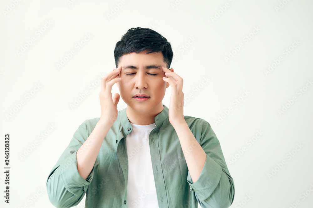 healthcare, pain, stress, age and people concept - Young asian man suffering from headache on white background healthcare, pain, stress, age and people concept - Young asian man suffering from headache on white background