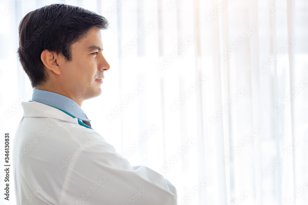 Doctor get determined, confident and crossed arm, looking forward. Physician stand near window at hospital room, looking through window. Doctor is expert of plastic surgery. Health care concept Doctor get determined, confident and crossed arm, looking forward. Physician stand near window at hospital room, looking through window. Doctor is expert of plastic surgery. Health care concept