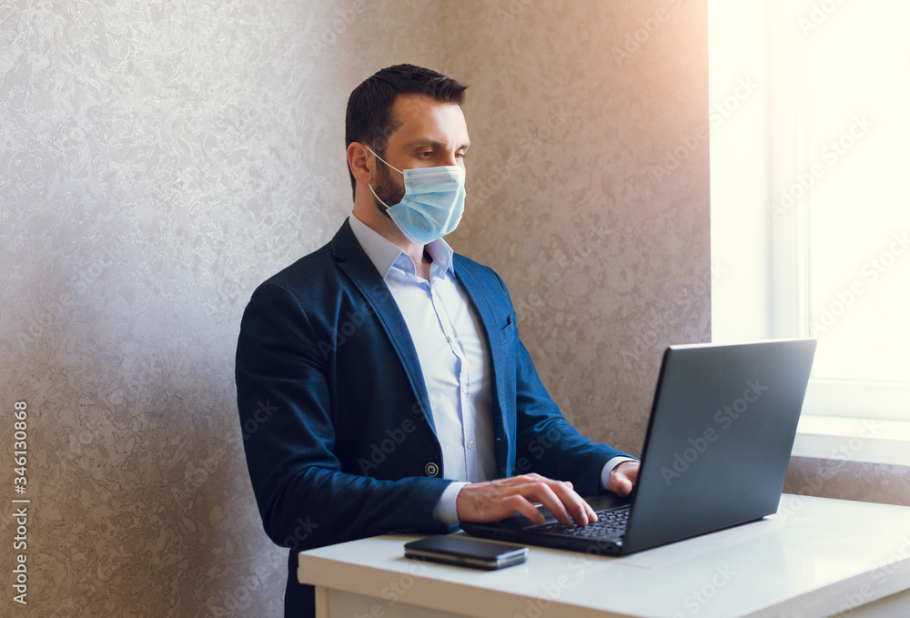Man in medical mask and jacket is working on laptop. Man in medical mask and jacket is working on laptop.